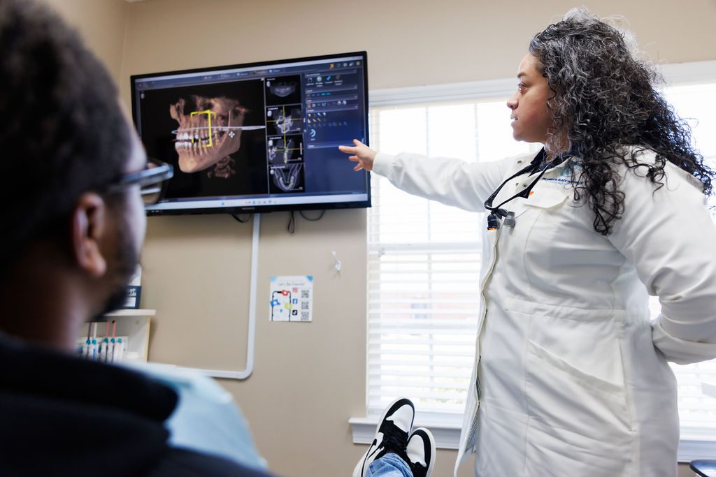 Dentist reviewing digital dental scan with patient in Valdosta GA office.