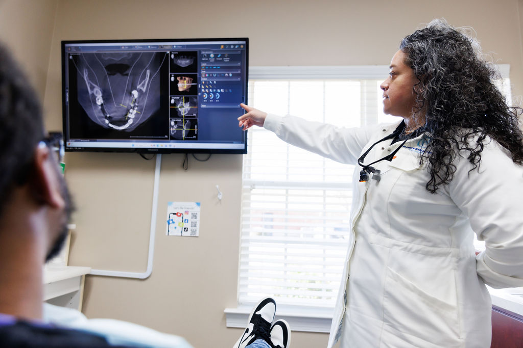 Best Dentist in Valdosta GA explaining digital scan results to patient.