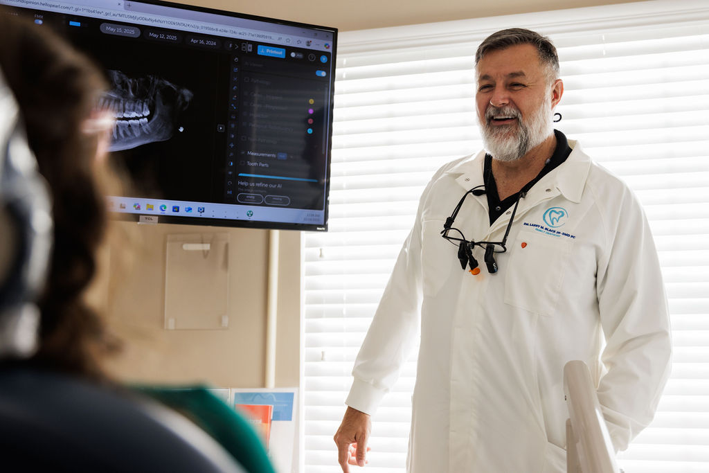 Dentist consulting with patient in Valdosta GA treatment room.
